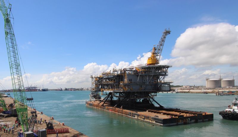 Offshore platform departs a yard on a barge