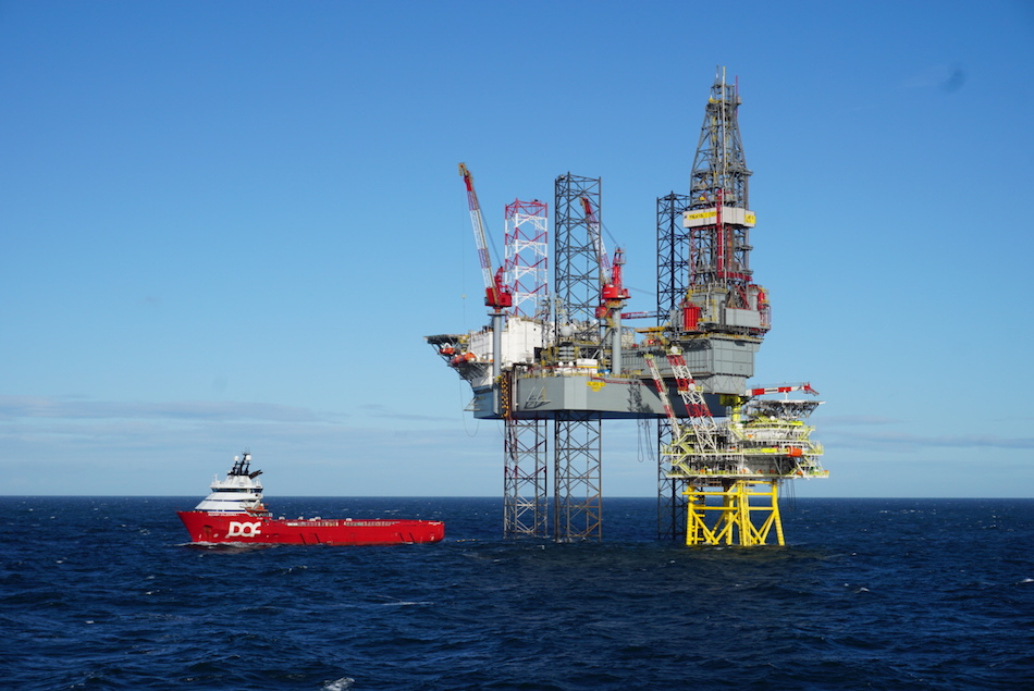 Tolmount platform with a drilling rig and a standby boat - Harbour