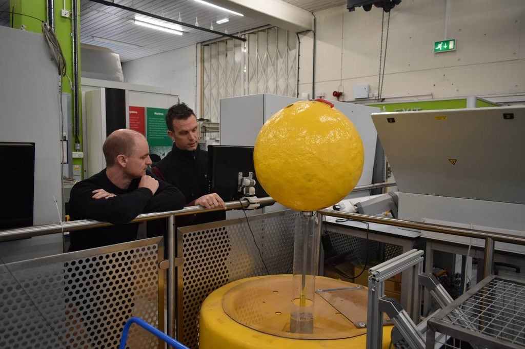 Researchers from Newcastle University and the University of Edinburgh discussing how to adapt the buoy for deployment in the North Sea (Courtesy of DER-IC)