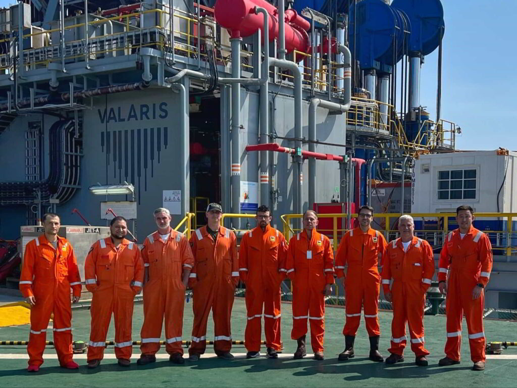 In the photo, from left: Adrian Toma, Eni HSE; MIGUEL DE LA CRUZ, Valaris Operations Support Engineer; William Dybas, OIM; Heath Brooks, Toolpusher; Raffaele Parodo, Eni Drilling Supervisor; Cristiano Paoli, Eni Well Construction Manager; Francesco Celentano, Eni Well Operations Manager; Keith Crane, Valaris Operations Manager; Robert Foor, Master.