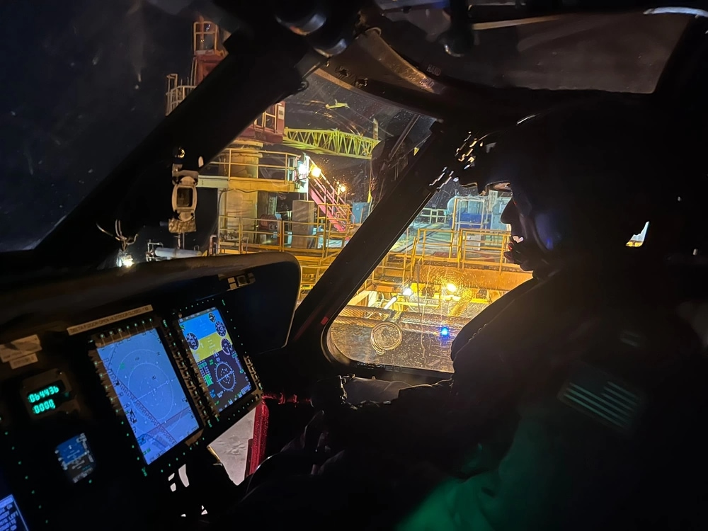 Coast Guard Air Station New Orleans MH-60 Jayhawk helicopter crew member sits inside cockpit of MH-60 Jayhawk helicopter near Venice, Louisiana. The aircrew was conducting a medevac on an offshore platform near Venice; Credit: U.S. Coast Guard Air Station New Orleans