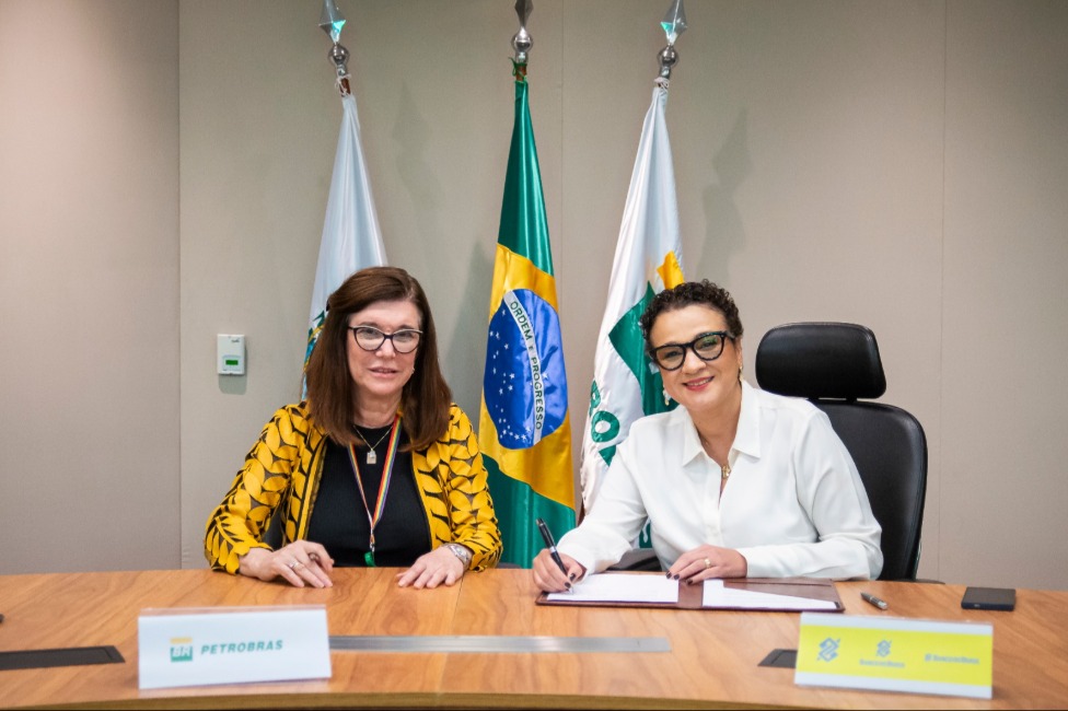 Two women sitting behind a desk