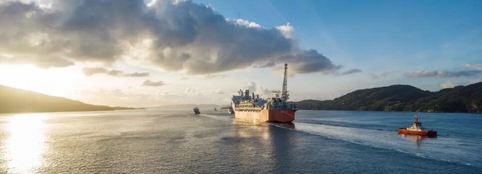 A large vessel at sea at sunset