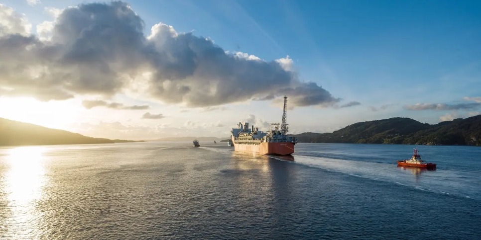 A large vessel at sea at sunset