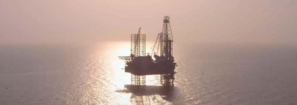 An offshore rig at sunset