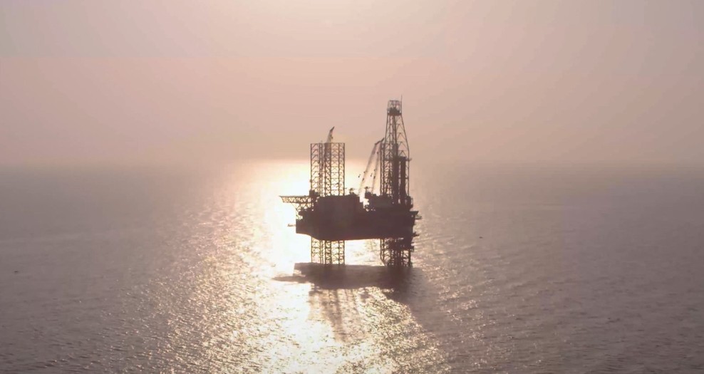 An offshore rig at sunset