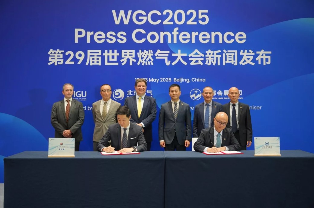 Several men signing documents