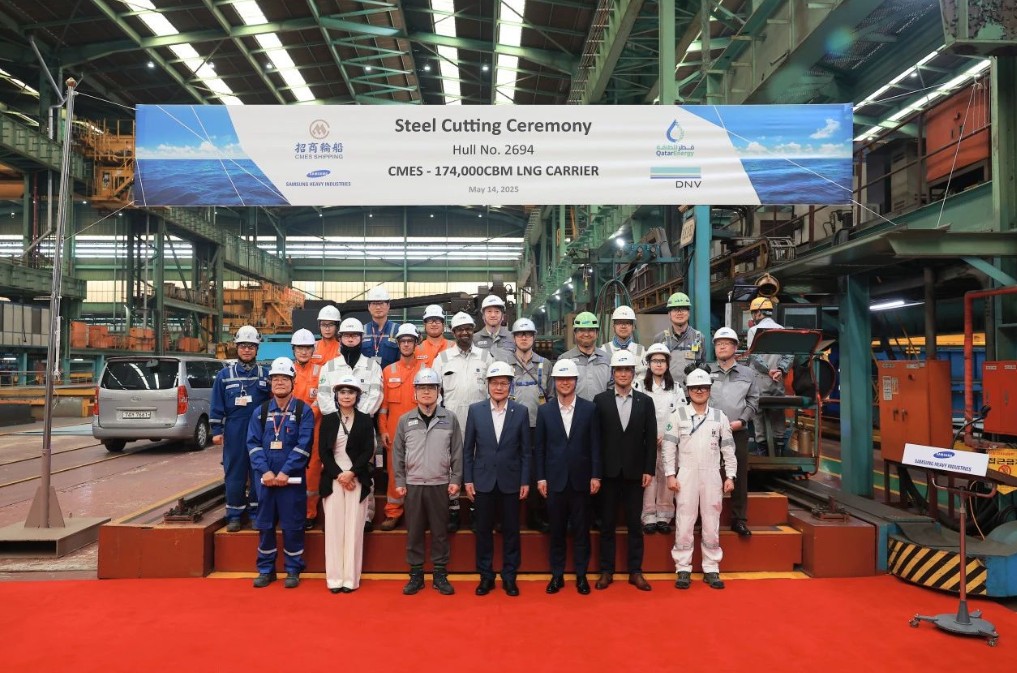 Men standing onstage at a steel cutting ceremony