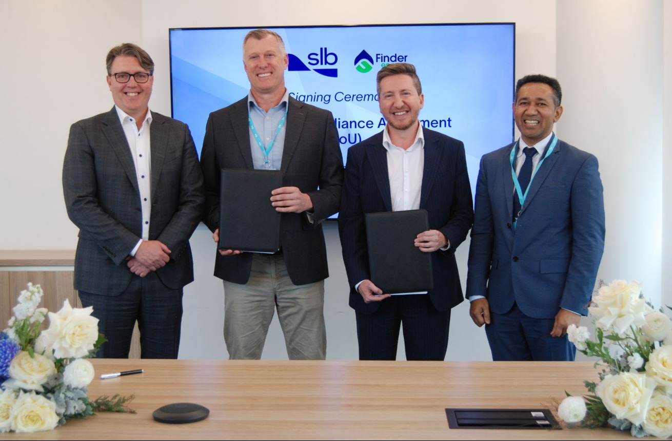 Four men standing and holding folders with signed documents