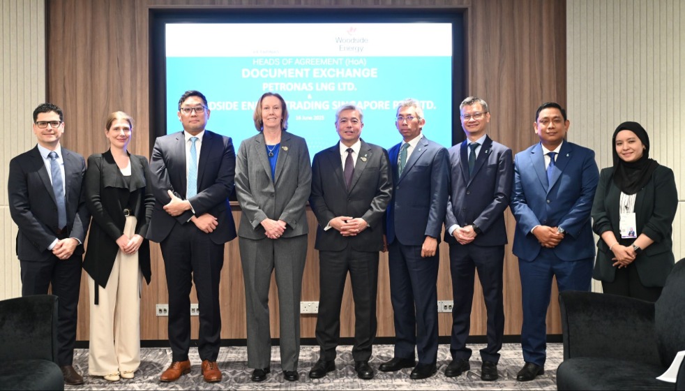 Several people standing in line at a document signing ceremony