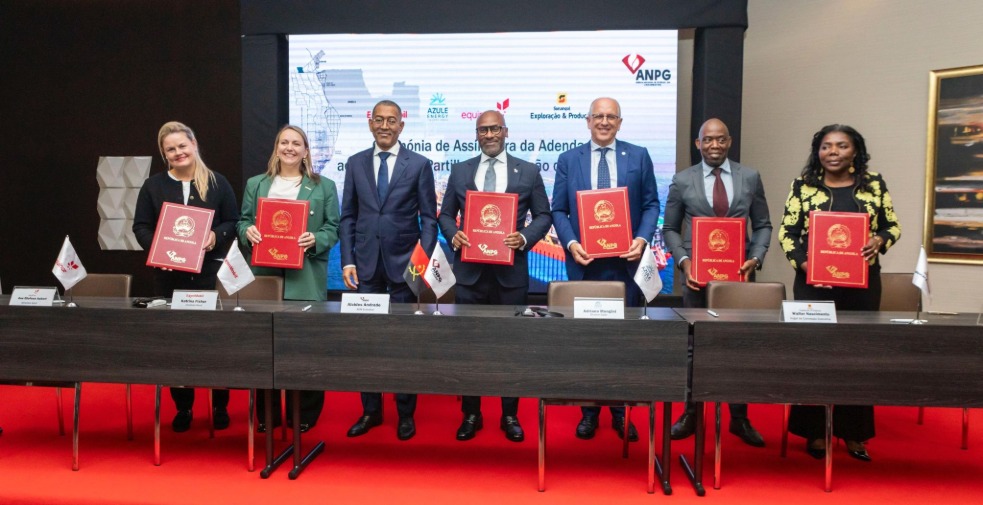 Several people standing in front of a desk on stage