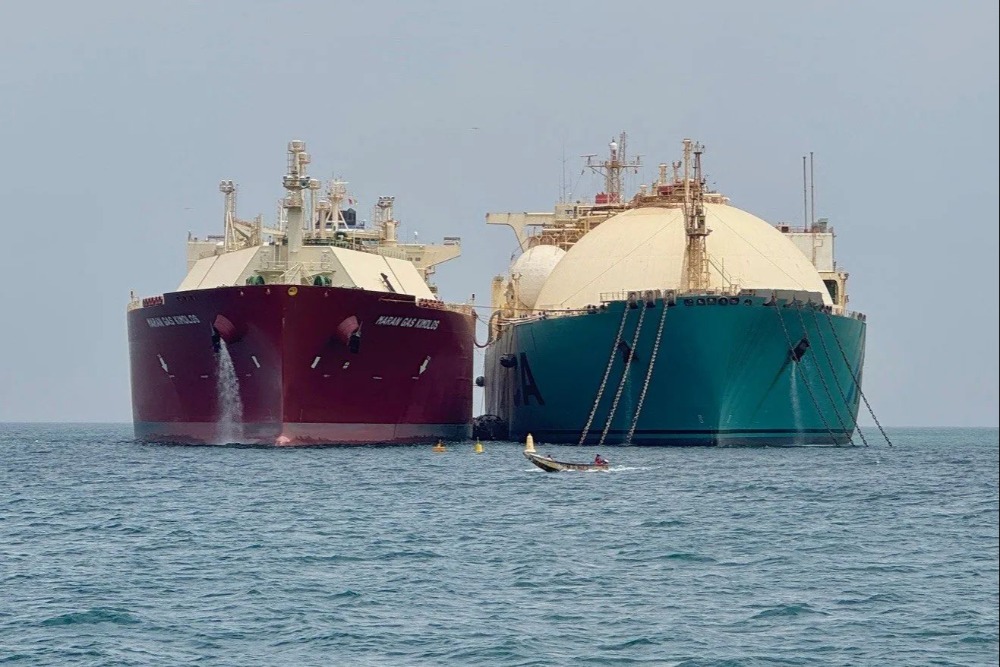 Two large vessels side by side at sea