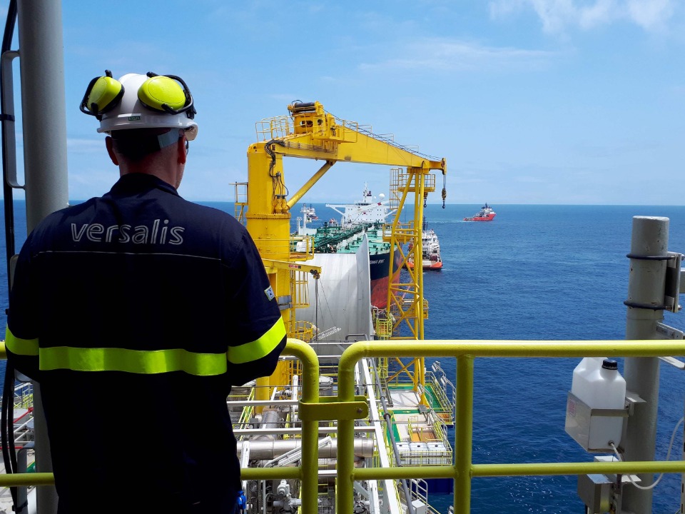Man seen from behind standing on an offshore platform