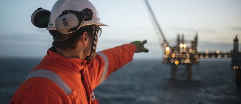 Man pointing at offshore platform