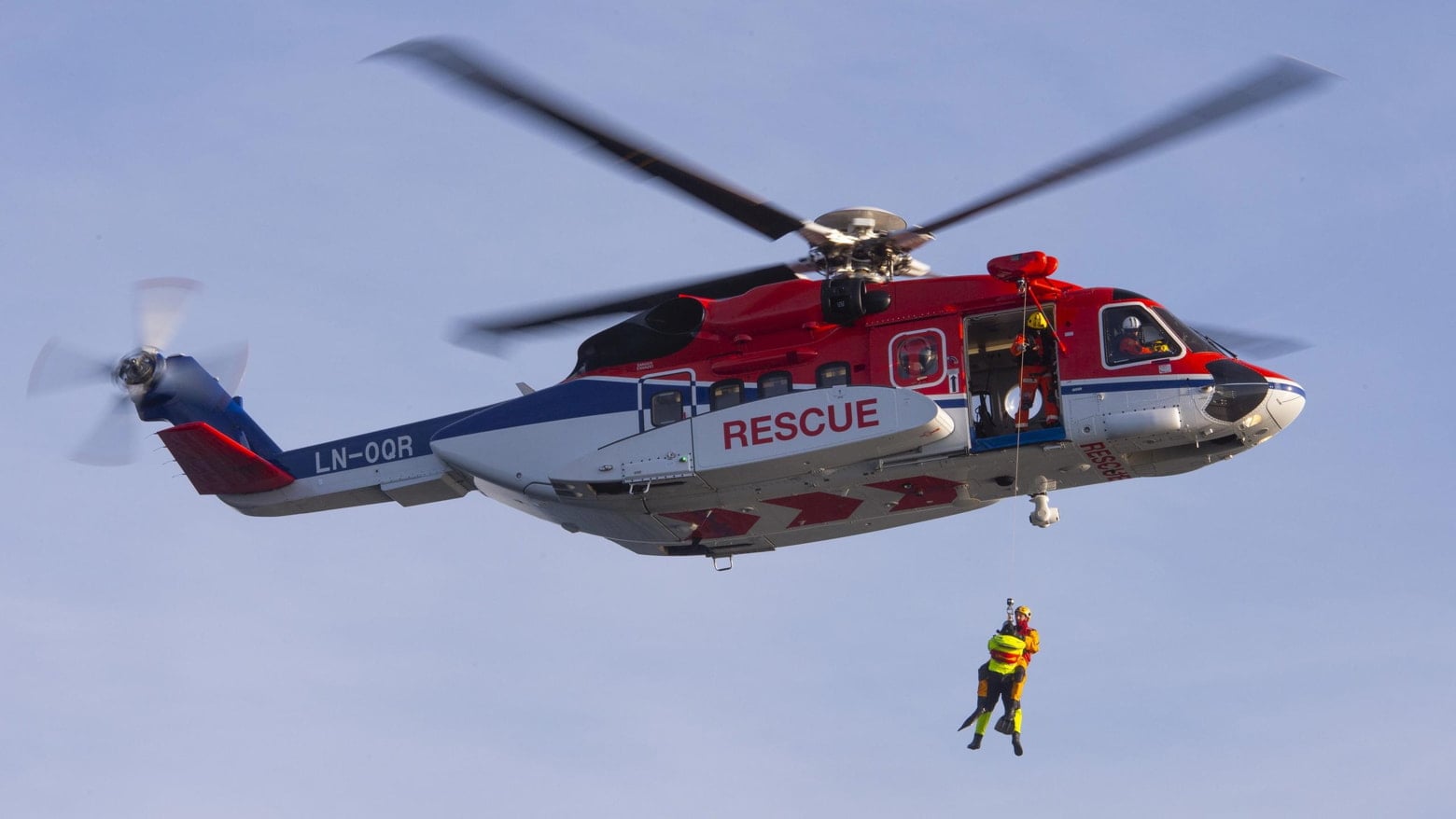 Rescue mission showing two men being lifted onto a helicopter; Courtesy of CHC Helicopter